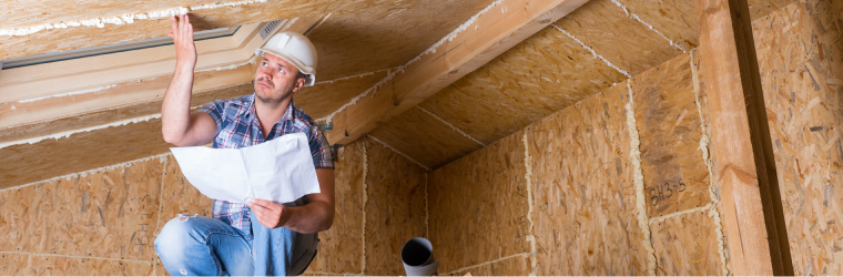 Home inspector checking attic